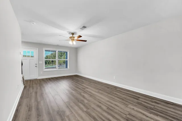 wooden floor in an empty room with a window