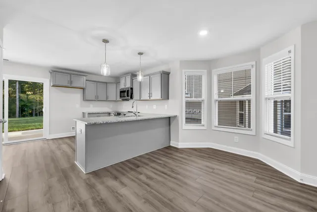 a view of kitchen with granite countertop cabinets and wooden floor