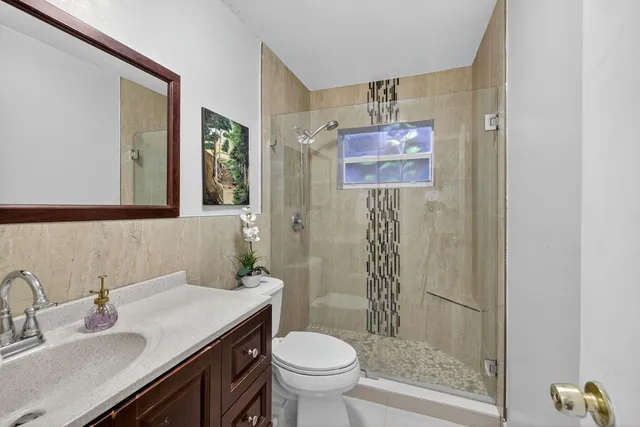 a bedroom with a bed dresser and a window