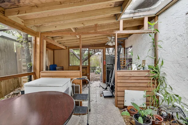 a dining room with furniture and a floor to ceiling window