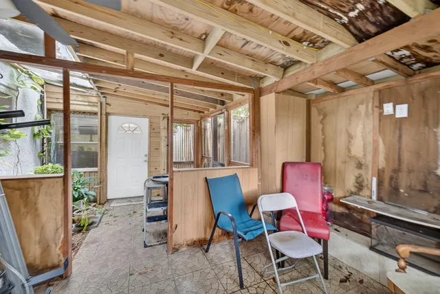 a backyard of a house with barbeque oven table and chairs