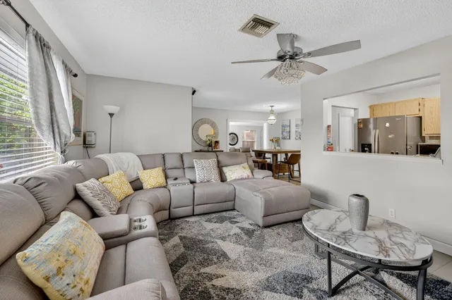 a kitchen with granite countertop a sink dishwasher stove and cabinets with wooden floor