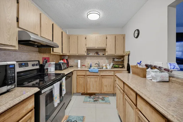 a kitchen with a sink stove and cabinets