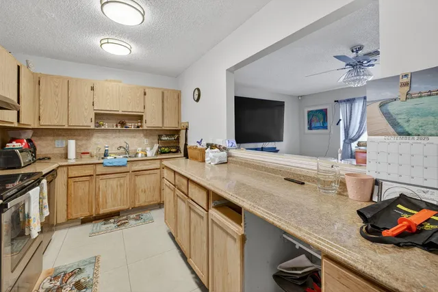 a view of a dining room with furniture and a chandelier