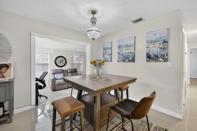 a view of a dining room with furniture and a chandelier