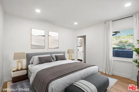 a bedroom with a balcony a bed and a couch