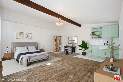 a spacious bedroom with a bed a couch and dresser