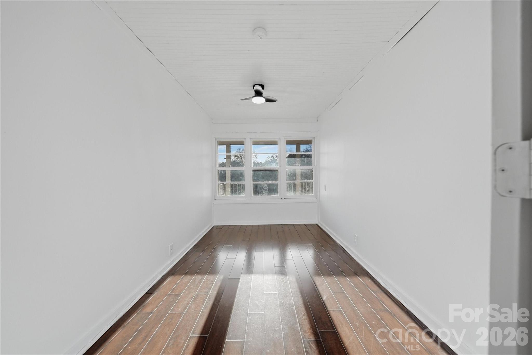 915 Airport Road Shelby, NC 28150 - Photo 14 of 37 wooden floor in an empty room with a window