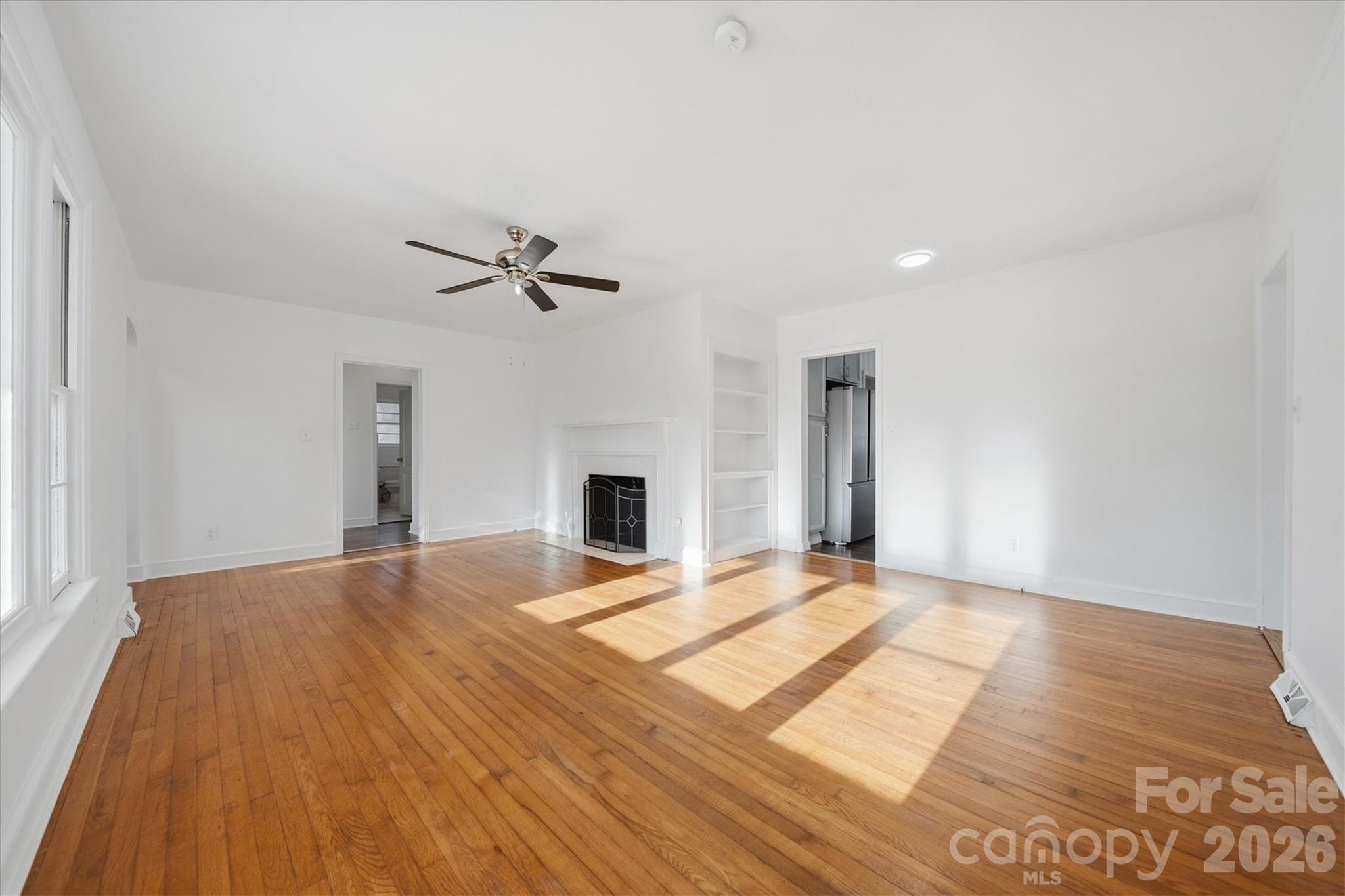 915 Airport Road Shelby, NC 28150 - Photo 6 of 37 a view of an empty room with a fireplace and a window