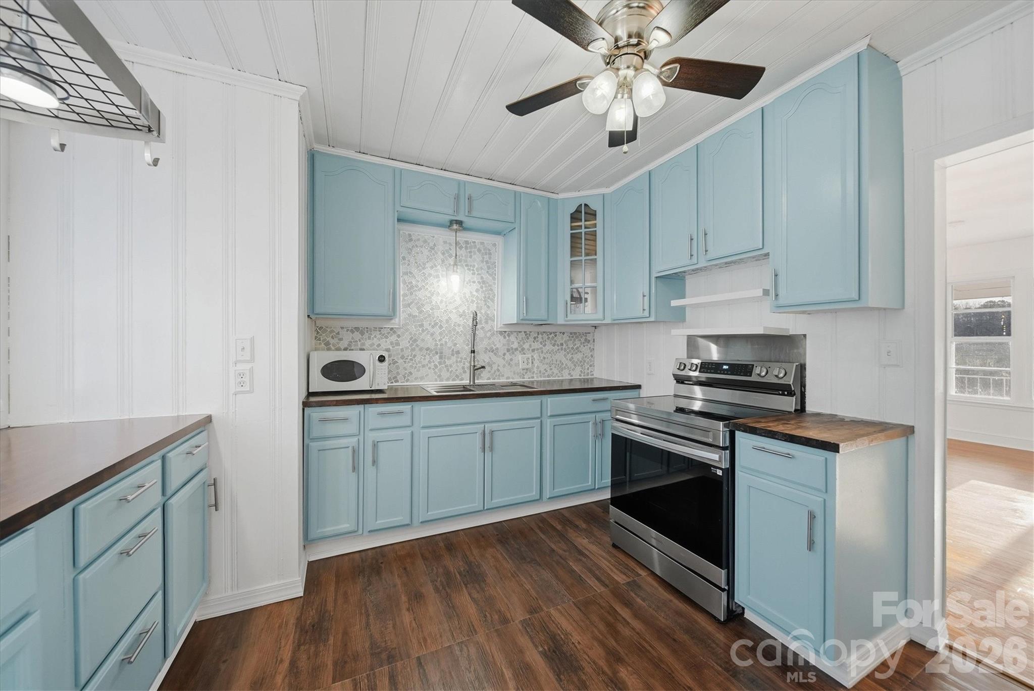 915 Airport Road Shelby, NC 28150 - Photo 9 of 37 a kitchen with granite countertop a sink cabinets stainless steel appliances and a window
