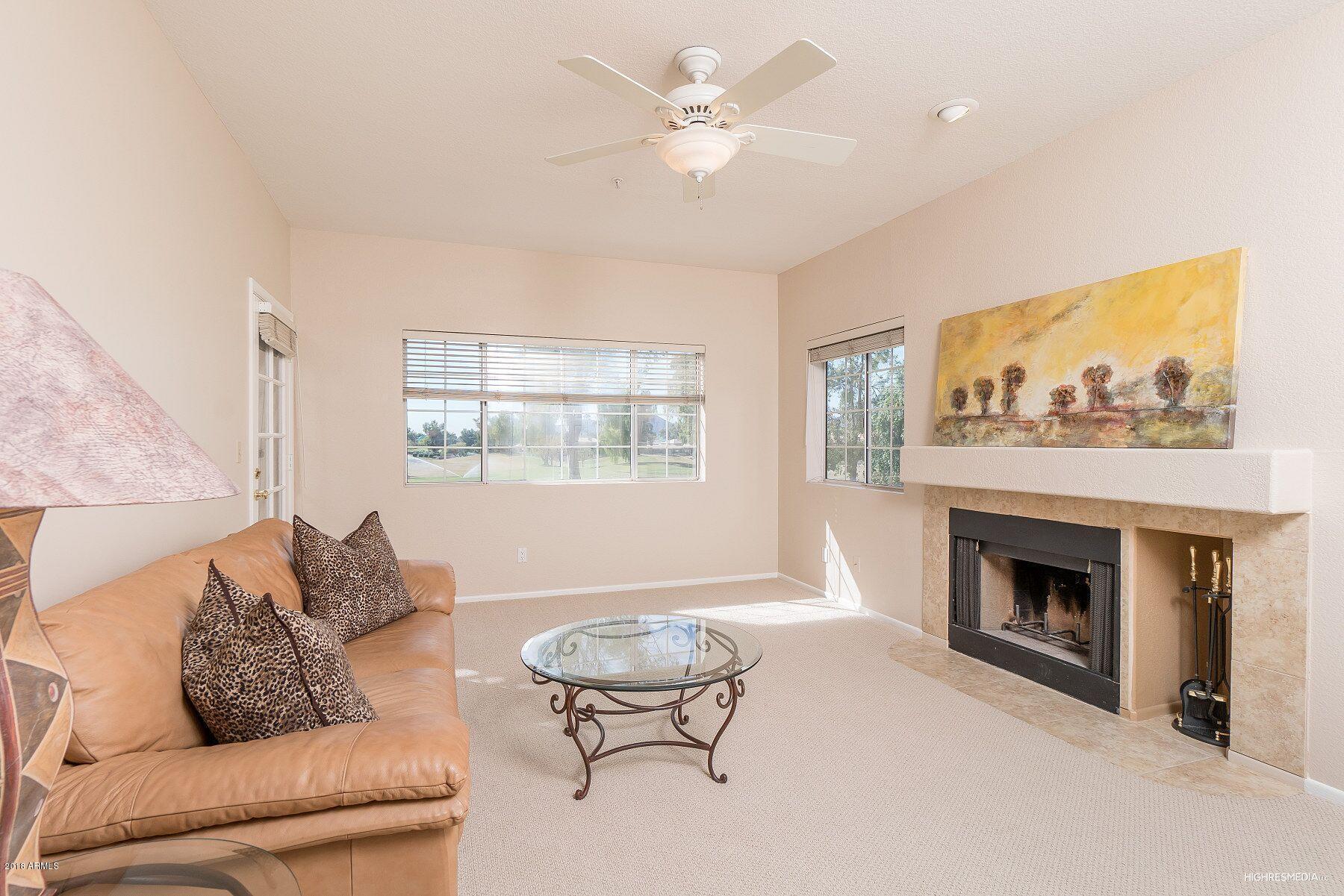 7710 East Gainey Ranch Road, Unit 225 Scottsdale, AZ 85258 - Photo 6 of 26 Cozy fireplace in living room