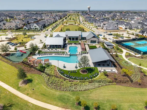 a view of a house with pool and chairs