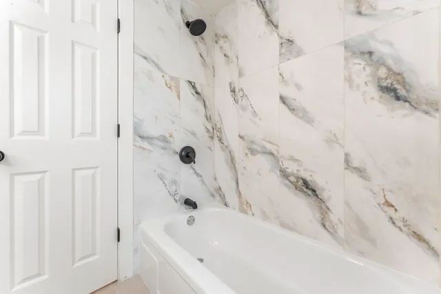 a bathroom with a bathtub and shower