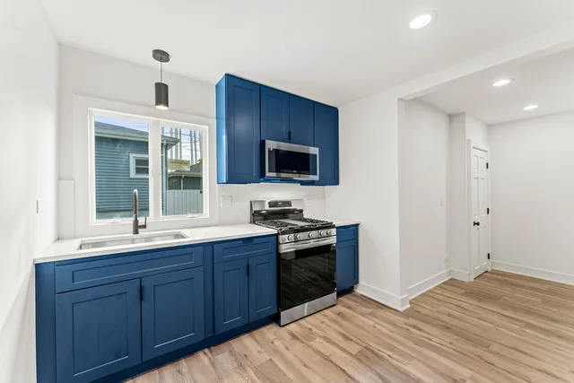 a kitchen with stainless steel appliances granite countertop a stove and a sink