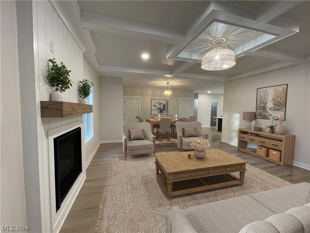7374 Crossfield Road Mentor, OH 44060 - Photo 5 of 35 Living room featuring a vertical shiplapped fireplace, and Crawford ceiling and dining area featuring a chandelier. *This picture has been virtually staged.
