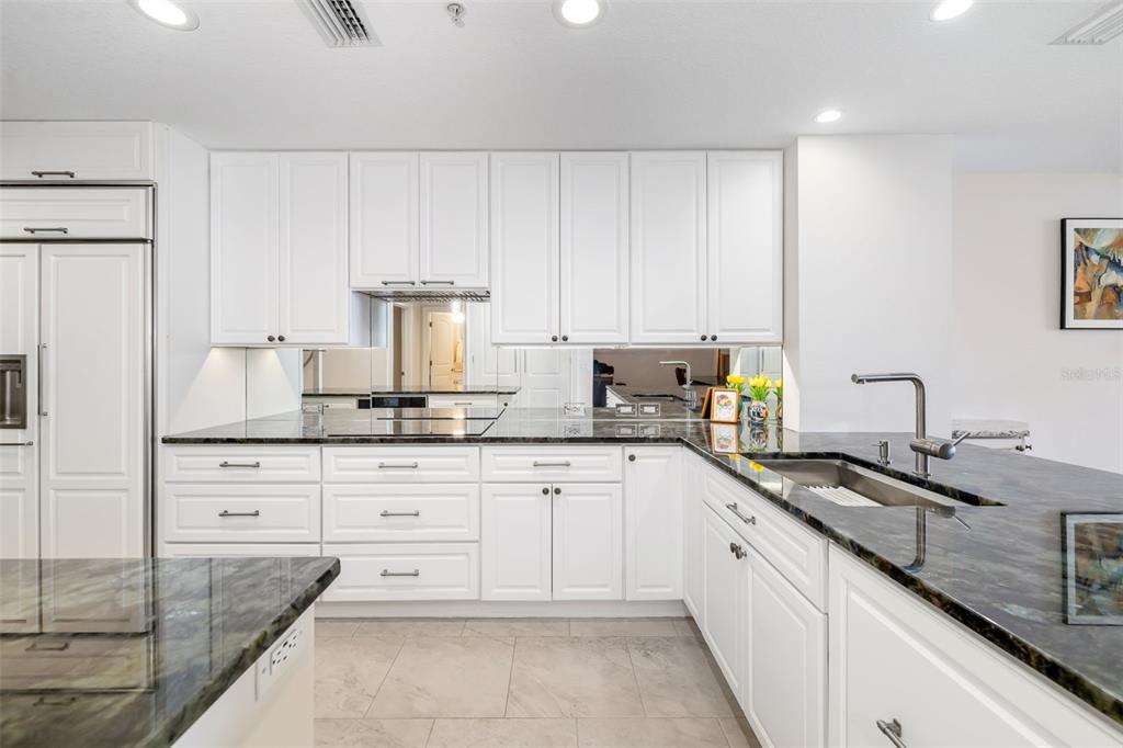 610 Riviera Dunes Way, Unit 503 Palmetto, FL 34221 - Photo 16 of 58 a kitchen with stainless steel appliances granite countertop a sink stove and cabinets