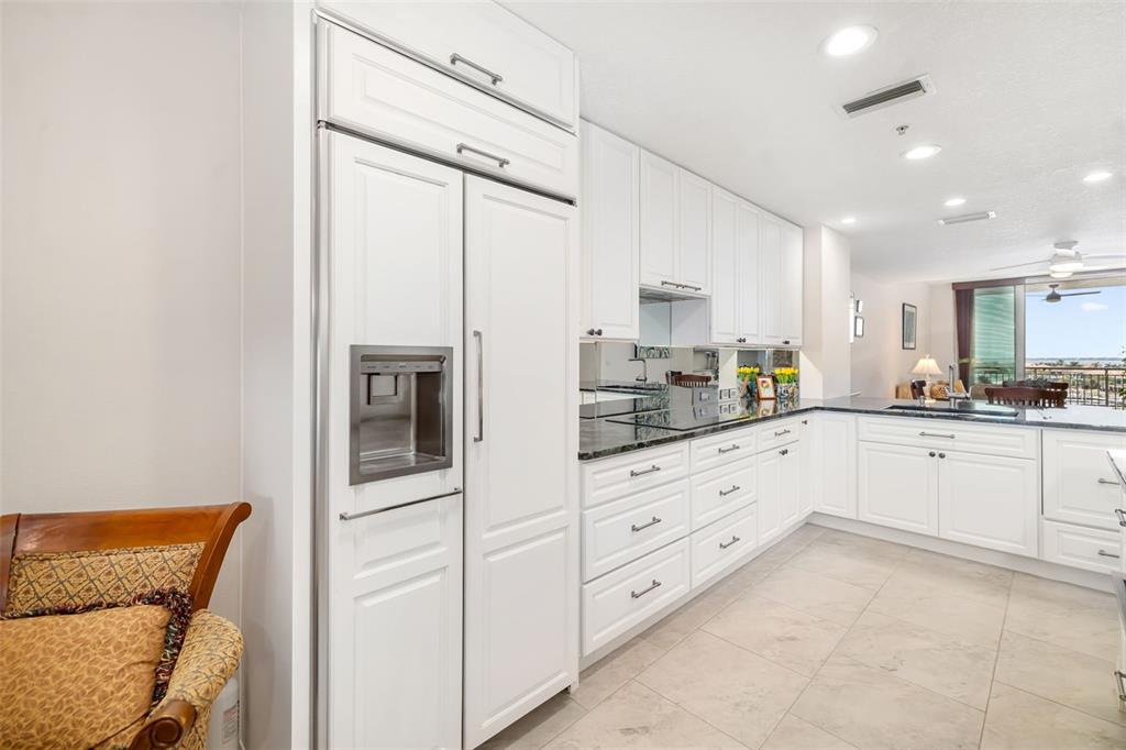 610 Riviera Dunes Way, Unit 503 Palmetto, FL 34221 - Photo 17 of 58 a kitchen with granite countertop white cabinets and white appliances