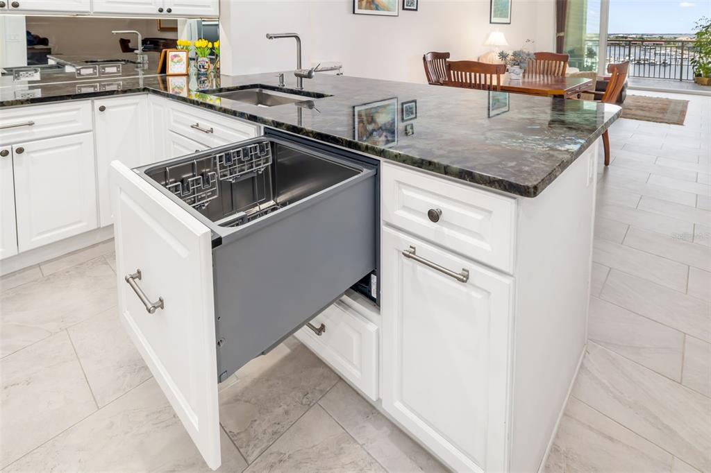 610 Riviera Dunes Way, Unit 503 Palmetto, FL 34221 - Photo 19 of 58 a kitchen with stainless steel appliances granite countertop a sink stove and refrigerator