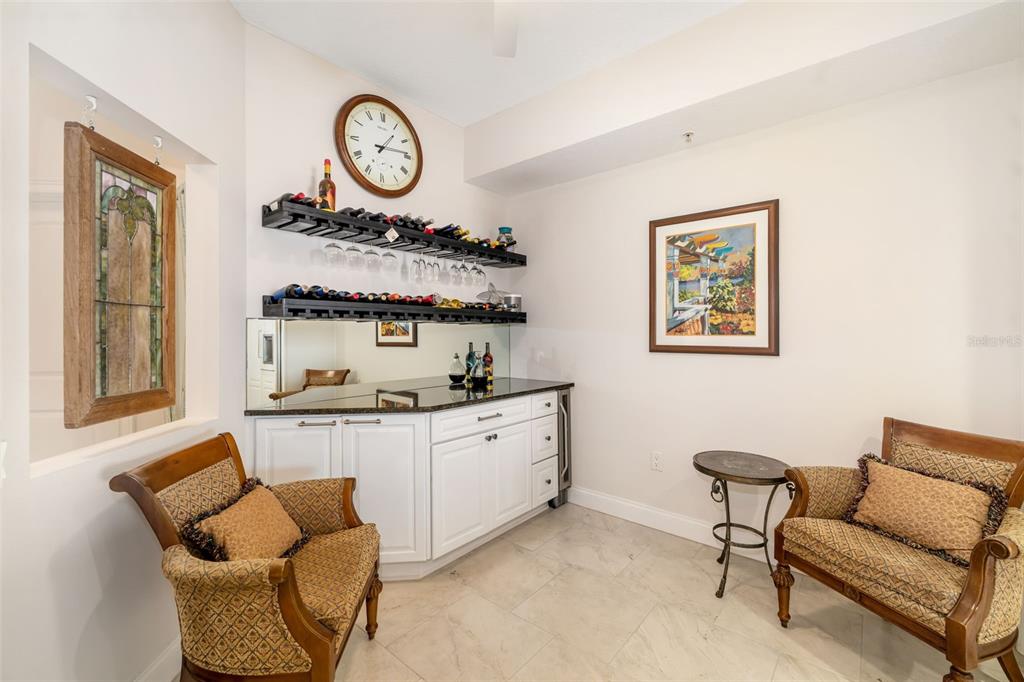 610 Riviera Dunes Way, Unit 503 Palmetto, FL 34221 - Photo 21 of 58 a living room with furniture and a clock