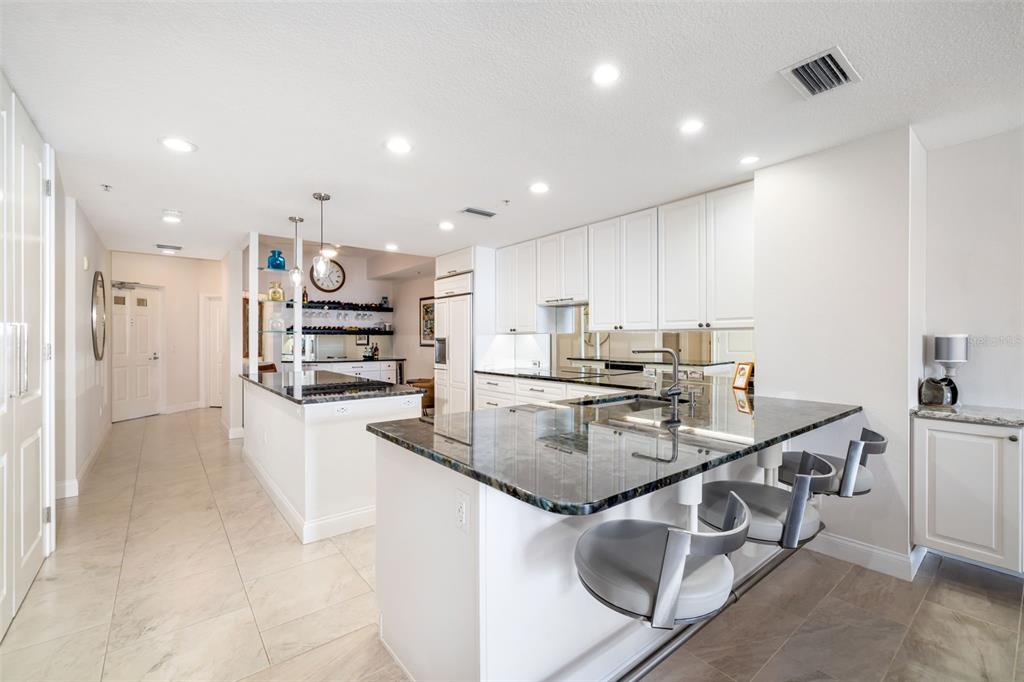 610 Riviera Dunes Way, Unit 503 Palmetto, FL 34221 - Photo 22 of 58 a kitchen with stainless steel appliances granite countertop a sink refrigerator and cabinets