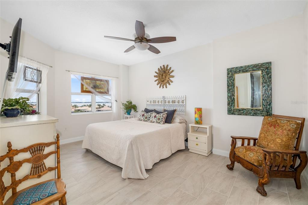 610 Riviera Dunes Way, Unit 503 Palmetto, FL 34221 - Photo 28 of 58 a bedroom with a bed and a couch