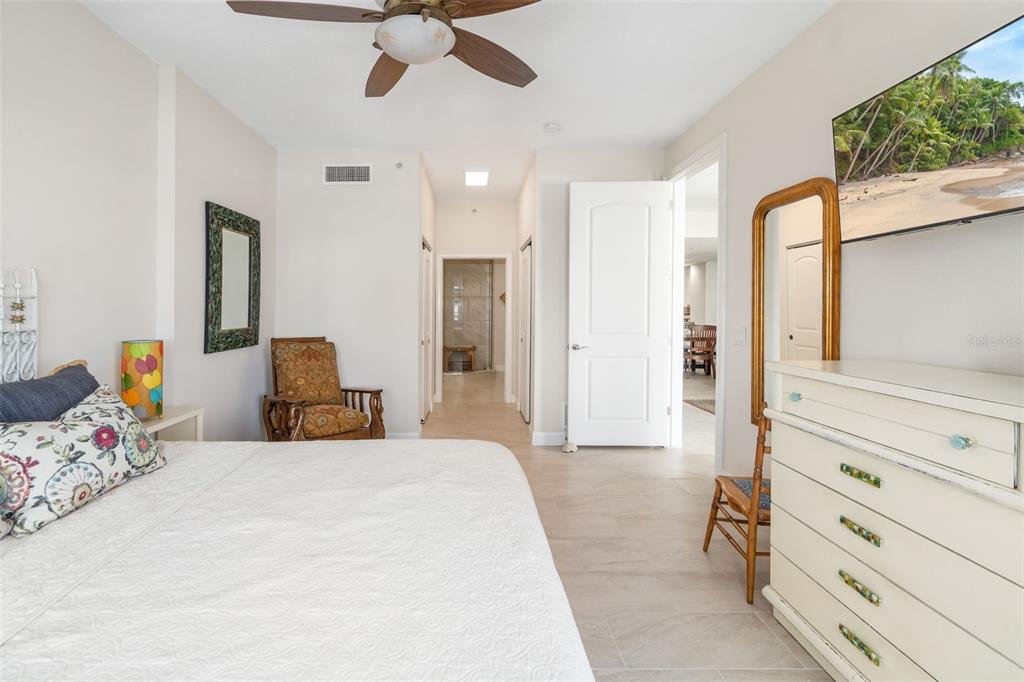 610 Riviera Dunes Way, Unit 503 Palmetto, FL 34221 - Photo 30 of 58 a bedroom with a bed and a chandelier