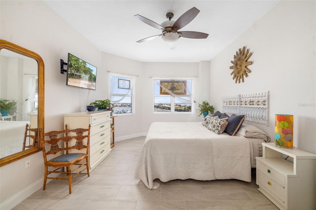 610 Riviera Dunes Way, Unit 503 Palmetto, FL 34221 - Photo 31 of 58 a bedroom with a bed a dresser and chair