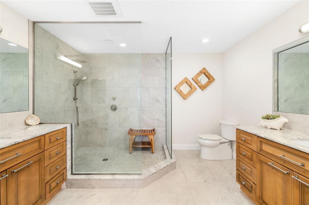 610 Riviera Dunes Way, Unit 503 Palmetto, FL 34221 - Photo 32 of 58 a bathroom with a granite countertop sink toilet and shower