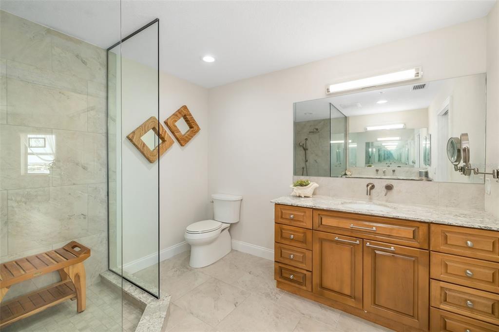 610 Riviera Dunes Way, Unit 503 Palmetto, FL 34221 - Photo 34 of 58 a spacious bathroom with a toilet sink and mirror
