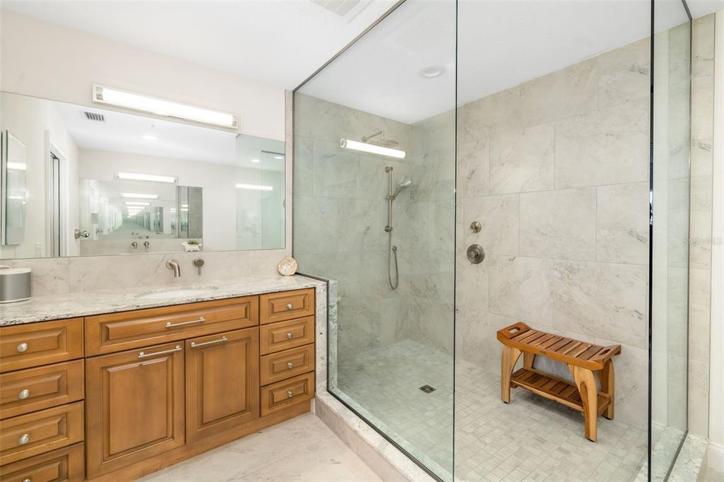 610 Riviera Dunes Way, Unit 503 Palmetto, FL 34221 - Photo 36 of 58 a bathroom with a shower sink and mirror