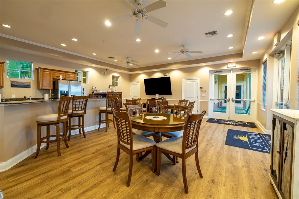 610 Riviera Dunes Way, Unit 503 Palmetto, FL 34221 - Photo 46 of 58 a view of a dining area with furniture and a flat screen tv