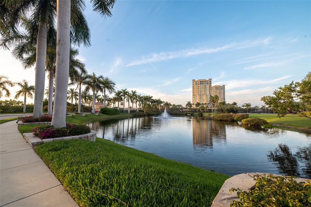 610 Riviera Dunes Way, Unit 503 Palmetto, FL 34221 - Photo 48 of 58 a lake view with palm trees next to a yard