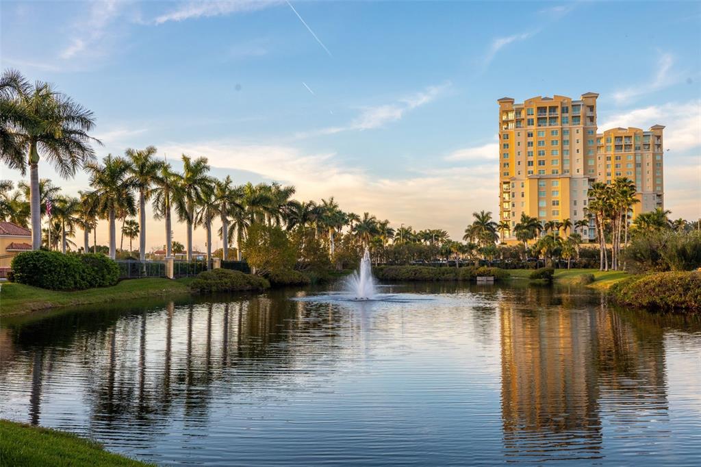 610 Riviera Dunes Way, Unit 503 Palmetto, FL 34221 - Photo 49 of 58 a lake view with boat and palm trees