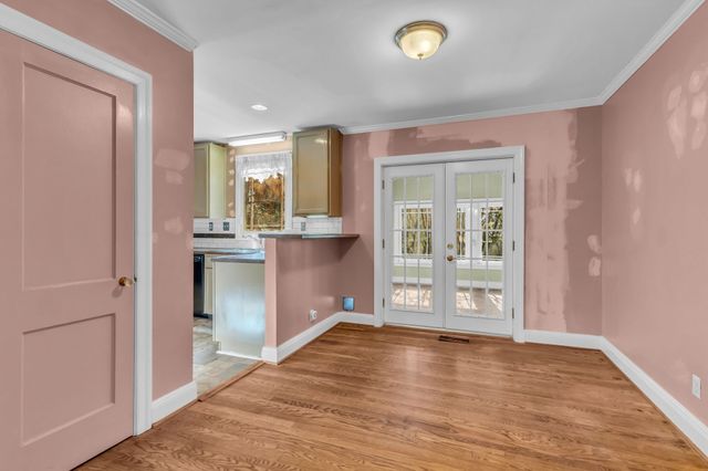a view of a room with wooden floor and windows
