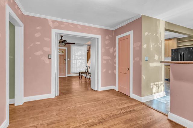 a bedroom with a bed and a view of living room