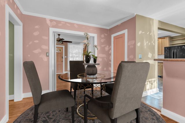 a view of an empty room with wooden floor and closet