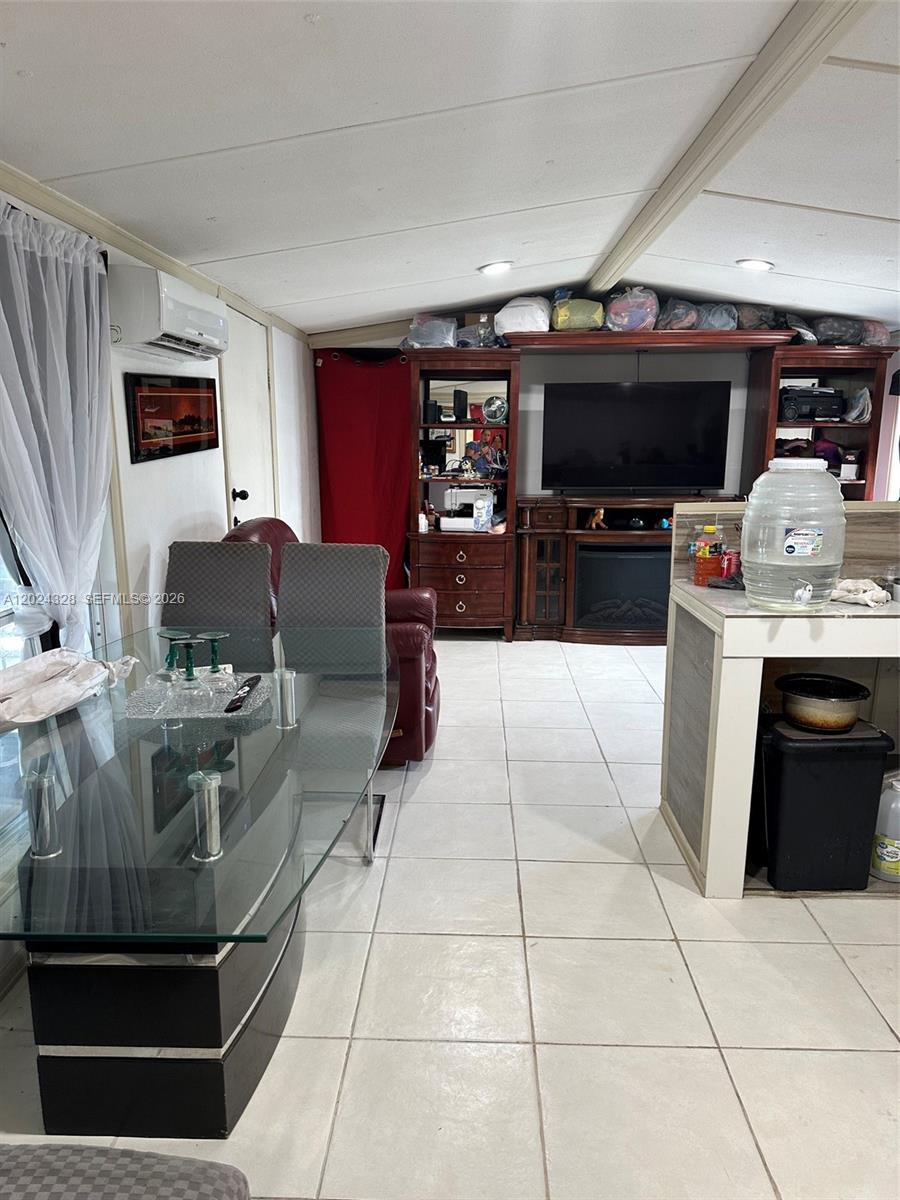625 North Quebrada Street Clewiston, FL 33440 - Photo 3 of 26 a living room with furniture a flat screen tv and kitchen view