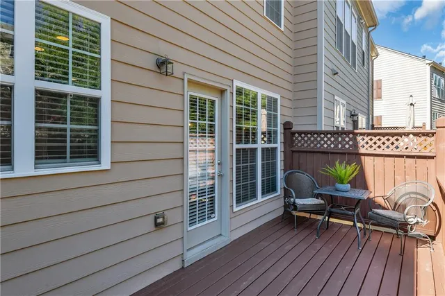 a view of a deck with table and chairs and wooden floor