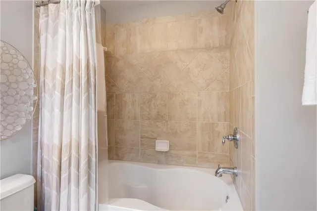 a bathroom with a bathtub and shower