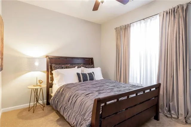 a bed sitting in a bedroom next to a window