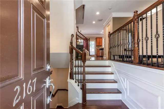 a view of entryway with wooden floor and stairs