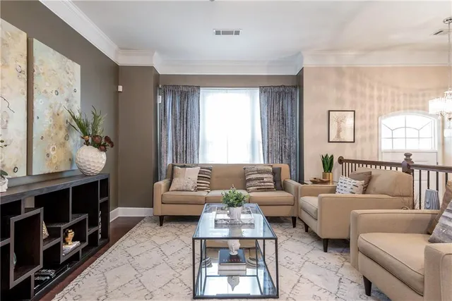 a living room with furniture a rug and a window