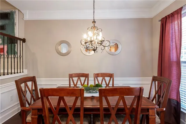 a view of a dining room with furniture clock and a window