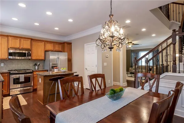 a view of a dining room with furniture a chandelier and wooden floor