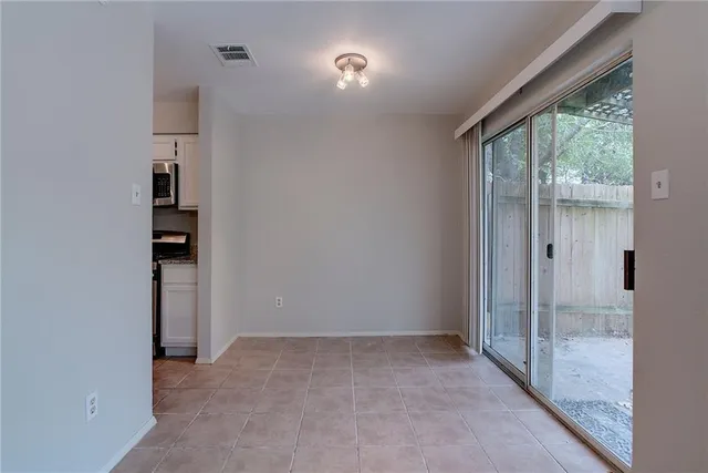an empty room that has a sliding door