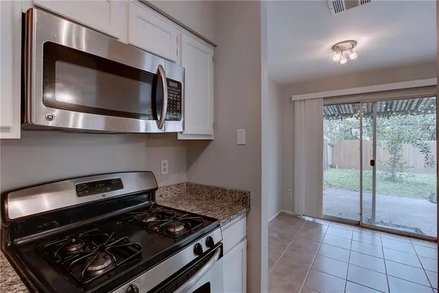 a kitchen with a stove and a microwave