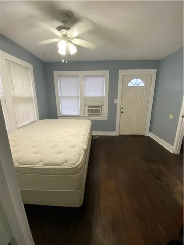 a room with wooden floor and window