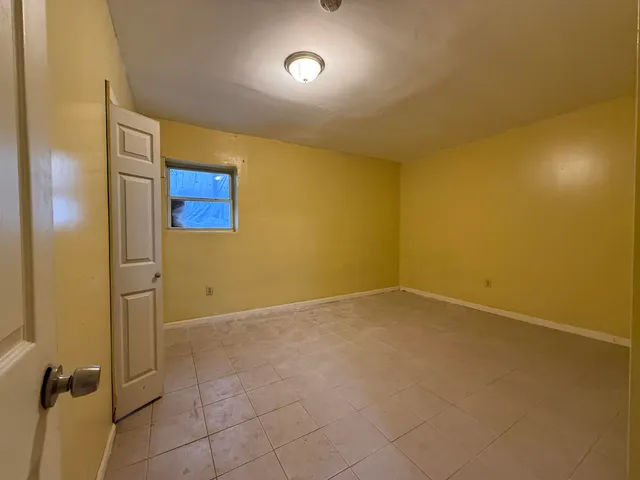 an empty room with a empty space and windows