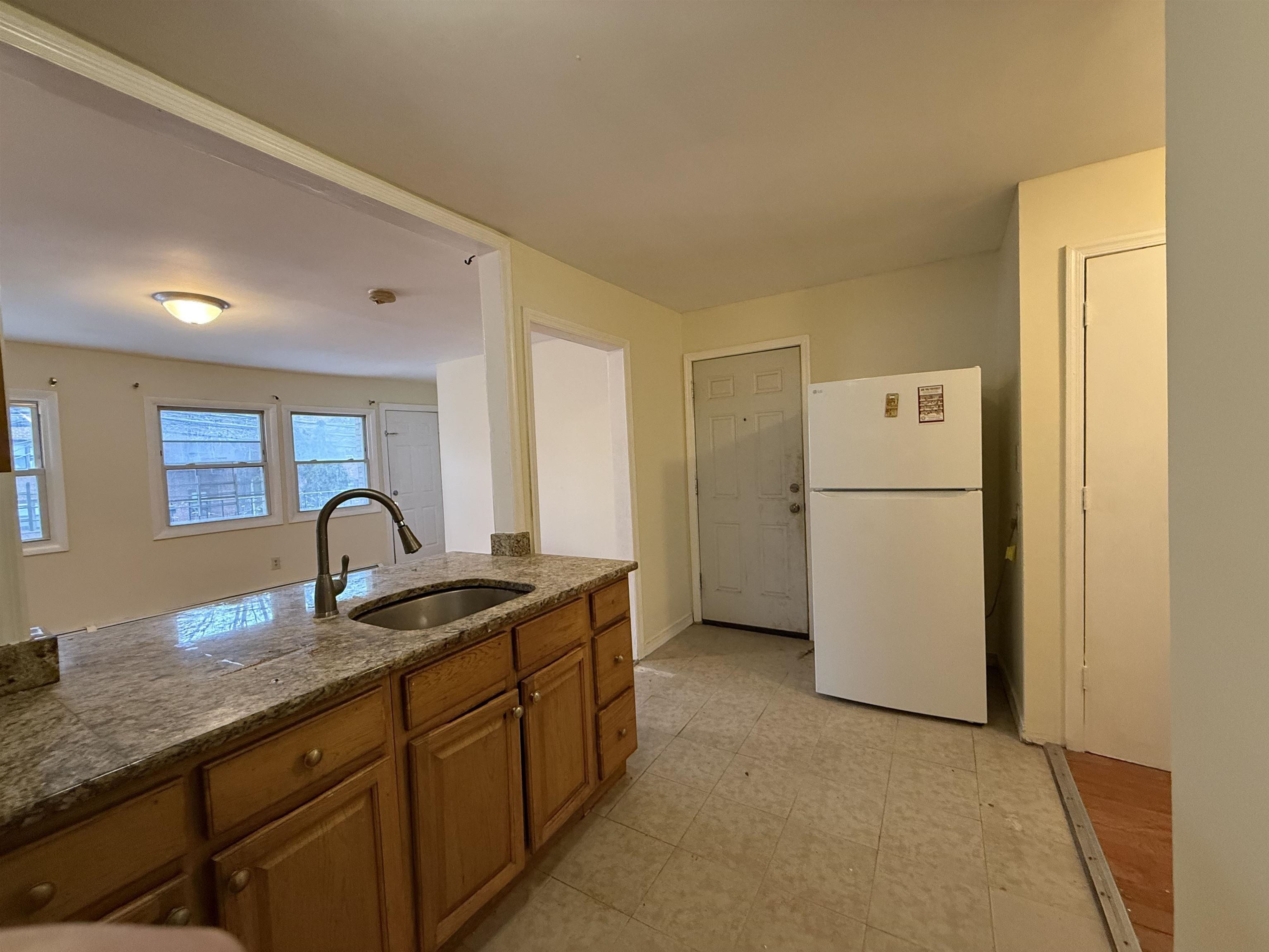 20 Dales Avenue, Unit 1 Jersey City, NJ 07306 - Photo 3 of 15 a kitchen with refrigerator a stove a sink and a refrigerator