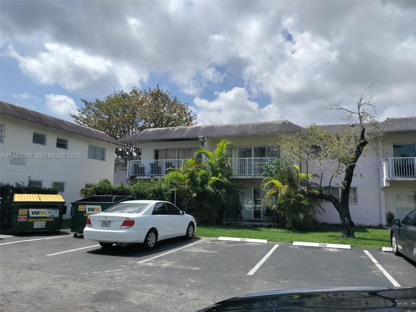7340 Southwest 82nd Street, Unit C205 Miami, FL 33143 - Photo 17 of 34 a front view of a house with garden